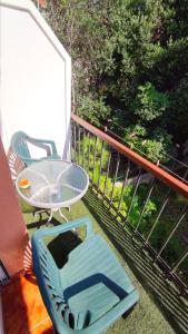 a blue chair and a table on a balcony at Apartments Vjeko in Split