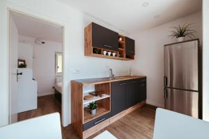 a kitchen with a sink and a refrigerator at Apartment Oddih with terrace and private SAUNA in Bled