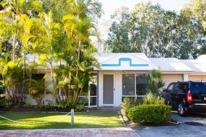 a truck parked in front of a house at 2 Bedroom Villa In Tropical Resort in Noosaville