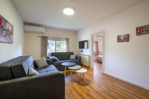 a living room with a couch and a table at אירוח הר אודם in Odem