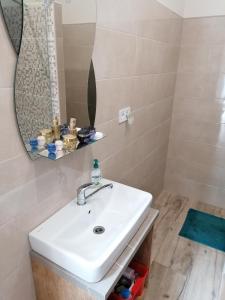 a bathroom with a white sink and a mirror at K-plus penzión in Štúrovo