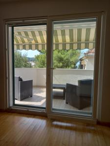 a room with sliding glass doors with a view of a patio at Branka Burak in Hvar
