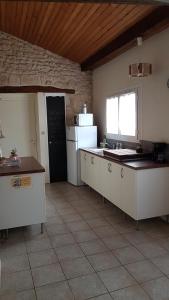 a kitchen with a white refrigerator and a window at le domaine de bellevue in Tanzac