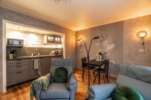 a living room with a couch and a table at B&B Poort van Westerwolde privé appartement met terras op zuiden in Alteveer