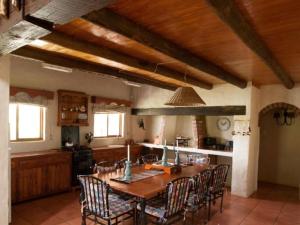 a large kitchen with a wooden table and chairs at Glen Aden in Dullstroom