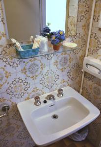 a bathroom with a sink and a mirror at Hotel Dei Cesari in Bellaria-Igea Marina