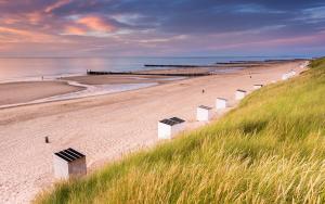 a sandy beach with a view of the ocean at Hotel Residentie Vlissingen in Vlissingen