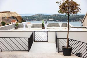 a balcony with a table and a tree at Andriana House in Šibenik