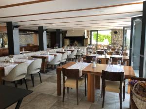 a dining room with wooden tables and chairs at La Villa - Beach house & Rooms in Crikvenica