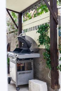 a grill sitting under a pergola at Andriana House in Šibenik