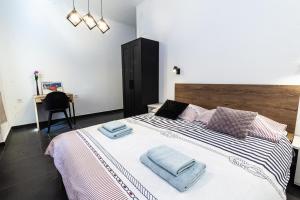 a bedroom with a large bed with towels on it at Andriana House in Šibenik