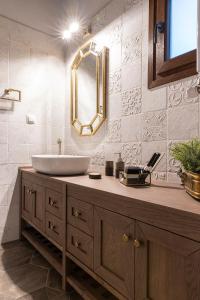 a bathroom with a sink and a mirror at Villa La Varik 3 in Litochoro