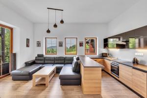 a living room with a couch and a table at Rezidence Rokytnice in Rokytnice nad Jizerou