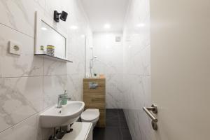 a white bathroom with a sink and a toilet at Andriana House in Šibenik +83 photos