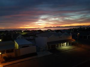 a view of a city with a sunset in the background at Bella Vista in Gansbaai