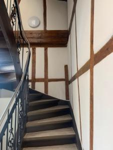 a staircase in a building with wooden beams at Gästehaus Hirsch 93 in Straubenhardt