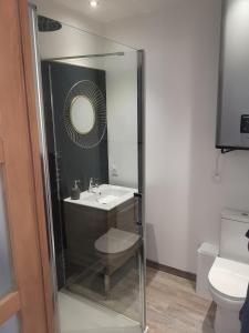 a bathroom with a sink and a mirror at studi'home in Rouen