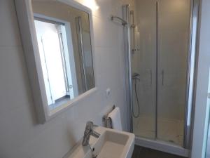 a bathroom with a sink and a shower with a mirror at Voramar 33A - Joana Attic in Port de Pollensa