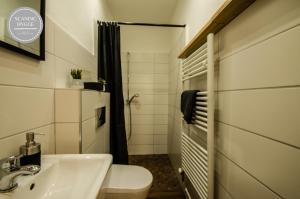 a small bathroom with a sink and a toilet at Ferienwohnung Scandic Hygge Bevern im Weserbergland in Bevern +21 photos