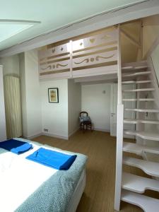 a bedroom with a bunk bed and a staircase at Elegant Duplex de Haut Standing de 230m2 in La Roche-sur-Foron