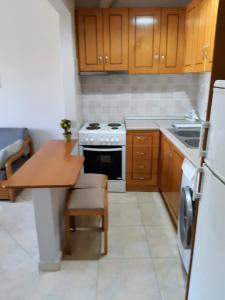 a small kitchen with a table and a stove at Helen's studio 1 in Myrina