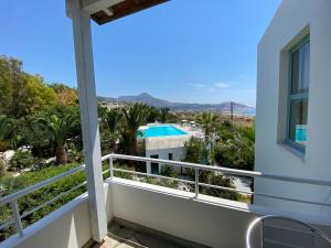 a balcony with a view of the pool at Hotel Plakures in Falasarna