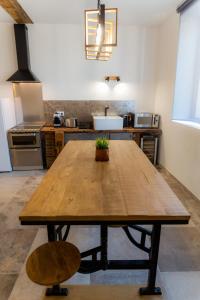 a large wooden table in a kitchen with a counter at l'Atelier du menuisier in Amboise
