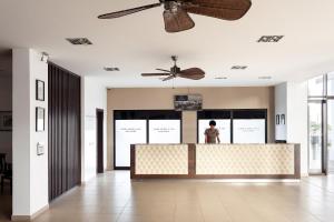 a person standing at a counter in a lobby at Melia Tortuga Beach - All Inclusive in Santa Maria