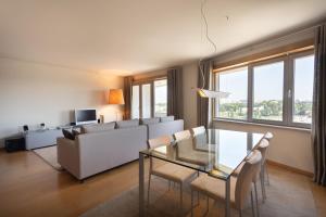 a living room with a couch and a glass table at Casa da Cidade in Vila Nova de Gaia