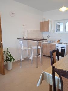 a kitchen with a table and some chairs in it at Apartment Davor in Gradac