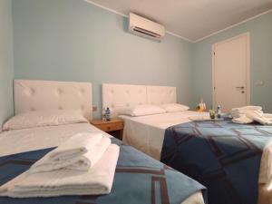 a room with two beds and a heater in it at Hotel Villa Mirella in Grado +48 photos