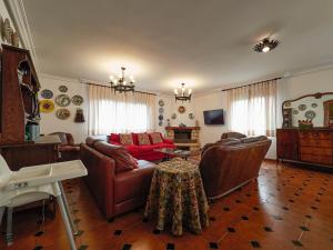 a living room with a couch and a table at Finca Engracia in Cudillero