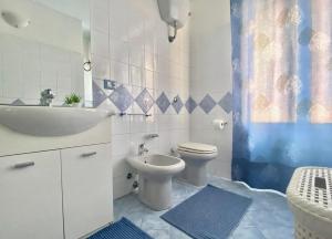 a bathroom with a toilet and a sink at Stella Marina in Santa Maria Navarrese