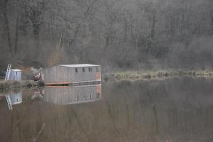 a building sitting on the side of a body of water at bateau du moulin girault in Panzoult