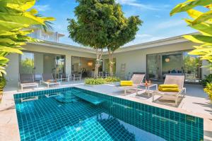 a swimming pool in the backyard of a villa at Villa White Orchid in Choeng Mon Beach