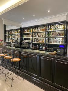 a bar with bar stools and bottles of alcohol at Hotel Zajazd Polonez in Tuczempy