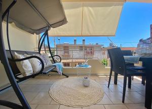 a balcony with a table and chairs and a window at Stella Marina in Santa Maria Navarrese