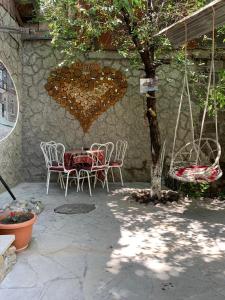 a patio with a table and chairs and a heart at Посуточный гостевой дом in Gyumri