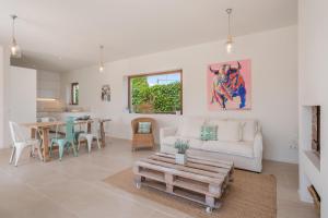 a living room with a couch and a table at Casa Puro in Cala Llombards