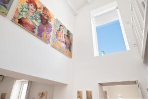 a room with paintings on the wall and a window at Oporto Classic Terrace in Porto