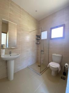 a bathroom with a toilet and a sink and a shower at The Mansion El Gouna in Hurghada