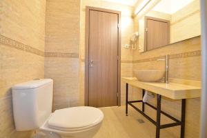 a bathroom with a toilet and a sink at AMADEUS RESIDENCE in Bucharest