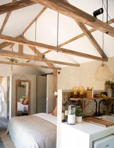 a bedroom with a bed in a room with wooden ceilings at LODGE & LOFT in Sassenheim