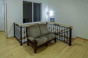 a chair sitting on a staircase with a window at Twins Hotel in Tbilisi City