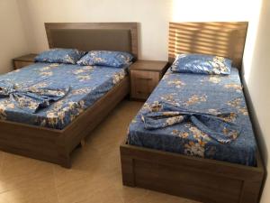 two beds in a room with two bedsskirts at Fabio Apartments Gjiri i Lalzit in Draç