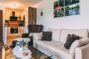 a living room with a white couch and a glass table at Feriendomizil-Sauerland FeWo 3 in Medebach