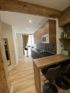a kitchen with wooden cabinets and a counter top at Apartamentos Cañalío in Santander