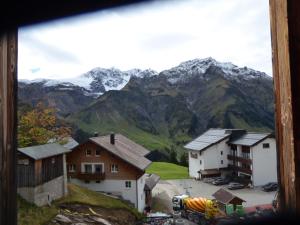 a view of a village with mountains in the background at Widderstein Apartments in Schröcken