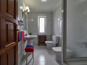 a bathroom with a toilet and a sink at Finca Engracia in Cudillero +42 photos