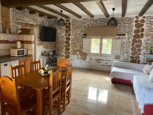 a kitchen and living room with a table and a couch at Les Mercès in Deltebre